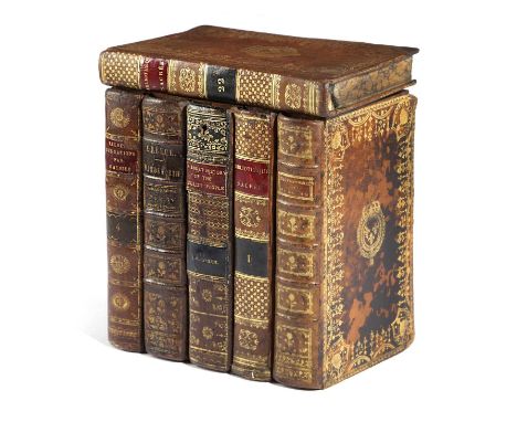 A CONTINENTAL FAUX LEATHER BOOK DECANTER BOXEARLY 20TH CENTURYthe interior lined with marbled paper and with twin divisions23