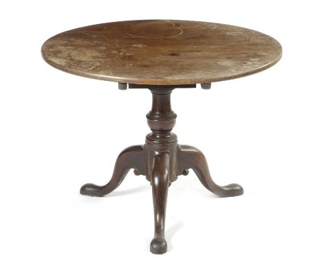 A GEORGE II MAHOGANY TRIPOD TABLE C.1740-50the circular tilt-top revolving on a birdcage on a baluster turned stem69.2cm high