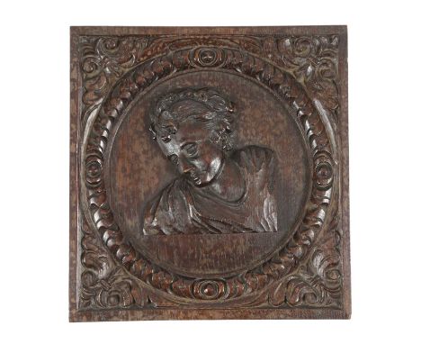 A CARVED OAK PANEL17TH CENTURYdepicting a classical portrait bust of a boy in an outer frame with leaf spandrels29.5 x 27.8cm