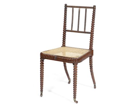 λ A GEORGE IV ROSEWOOD BOBBIN TURNED SIDE CHAIRC.1825-30the cane seat with gadrooned borders with a central leaf, on ceramic 