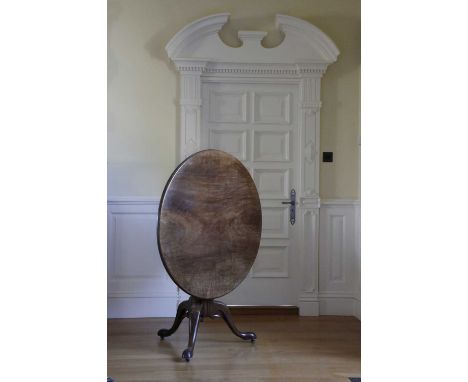A GEORGE II MAHOGANY TRIPOD TABLECHIPPENDALE PERIOD, C.1750the circular tilt-top on a turned gun barrel stem, with pierced an