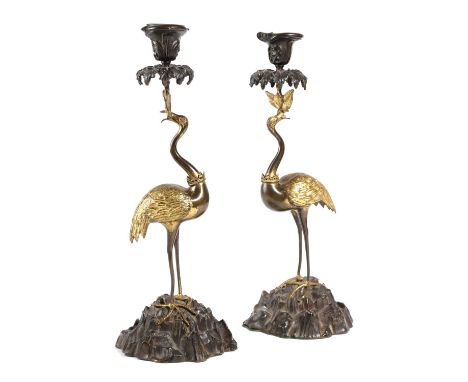 A PAIR OF WILLIAM IV GILT BRONZE AND PATINATED CANDLESTICKS BY THOMAS ABBOTT, C.1830-35each in the form of a stork wearing a 