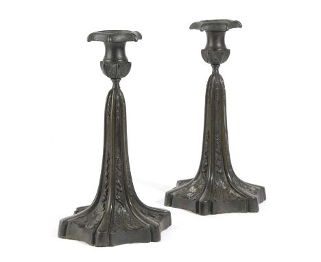 A PAIR OF BRONZE CANDLESTICKS19TH CENTURYeach with a hexagonal drip-pan above a tapering stem and spreading foot cast with sc