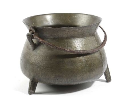 A BRONZE CAULDRONPROBABLY WEST COUNTRY, 17TH CENTURYwith a flared rim, an iron swing handle and angular lugs, on moulded trip