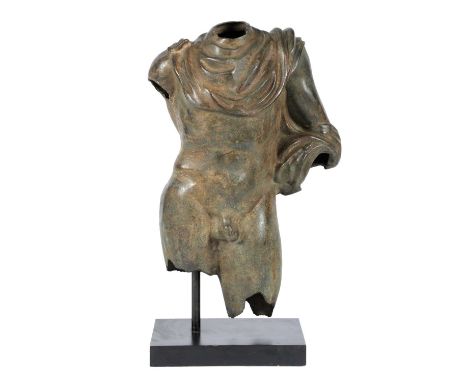 AN ITALIAN BRONZE CLASSICAL TORSOAFTER THE ANTIQUE, 20TH CENTURYcast as a male nude with a drape around his neck, on an eboni