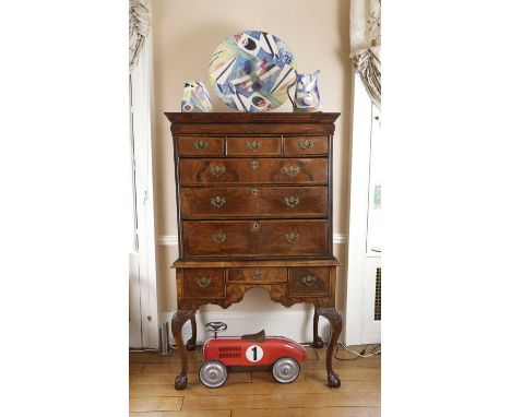 A WALNUT CHEST ON STANDEARLY 18TH CENTURY AND LATERthe cushion frieze drawer above three short and three long drawers, the la