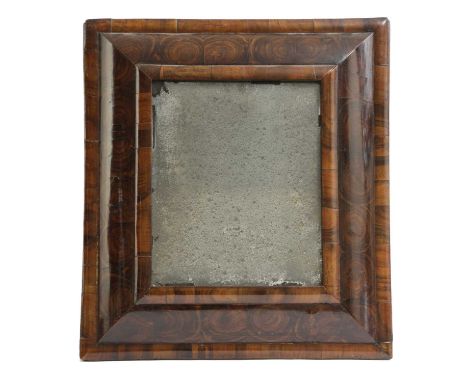A WILLIAM AND MARY OYSTER VENEERED CUSHION FRAME WALL MIRRORC.1700the rectangular plate inside a moulded frame, originally wi