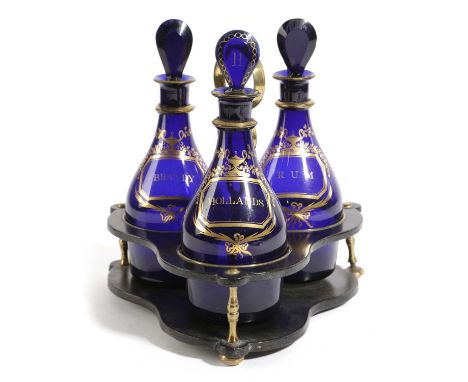 A SET OF THREE BRISTOL BLUE DECANTERS AND STOPPERS ON STANDC.1800each of mallet form with a gilt label inscribed 'Brandy', 'R