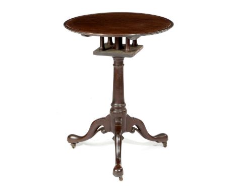 A GEORGE II MAHOGANY TRIPOD TABLEC.1750the circular dished tilt-top revolving on a birdcage, on a gun barrel stem on pierced 