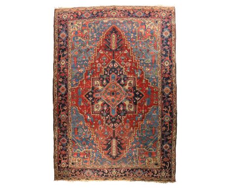 AN HERIZ CARPETNORTH WEST PERSIA, C.1900the abrashed madder field of angular vines centred by a salmon pink, pale lemon and i
