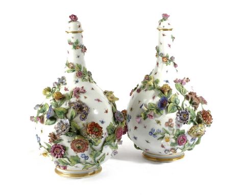 A PAIR OF MEISSEN PORCELAIN BOTTLE VASES AND COVERS19TH CENTURYof ovoid form with slender necks, extensively encrusted with f