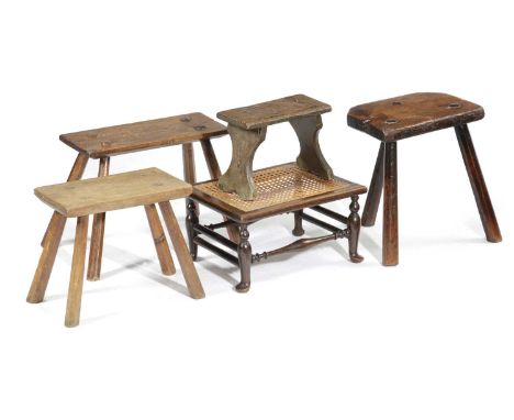 A COLLECTION OF COUNTRY STOOLS18TH CENTURY AND LATERincluding an ash dairy stool, an oak stool with a caned seat on cabriole 