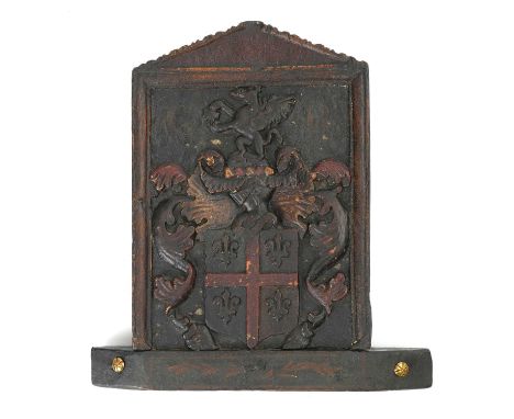 AN OAK AND POLYCHROME DECORATED ARMORIAL CRESTC.1660-80carved with a quartered shield flanked by foliage, beneath a helmet an