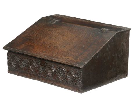 A CHARLES II BOARDED OAK DESK BOXC.1660the top with channel moulded and chip carved ends, above a conforming slope, fitted wi