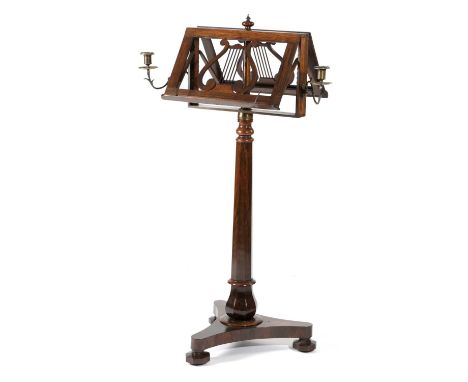 λ AN EARLY VICTORIAN ROSEWOOD DUET MUSIC STANDC.1840with lyre shaped adjustable hinged rests and bronze sconces, on a faceted