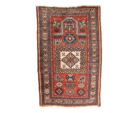 A FACHRALO PRAYER RUGSOUTH CENTRAL CAUCASUS, C.1900the madder field of rosettes and latch hook guls centred by an ivory panel