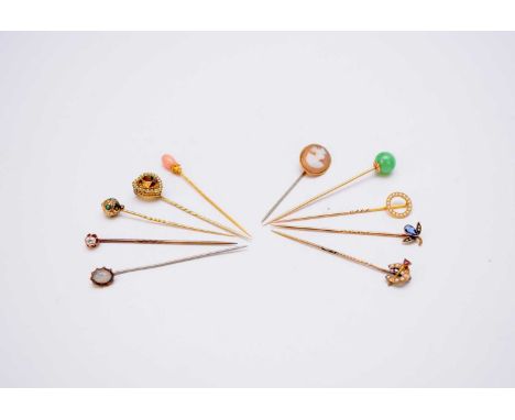 A collection of ten stick pins, comprising; a late 19th century coral set example, a citrine and seed pearl heart shaped pin,