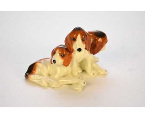 A Royal Worcester group of three foxhound puppies, modelled by Doris Lindner, circa 1936-50s, printed factory and registratio