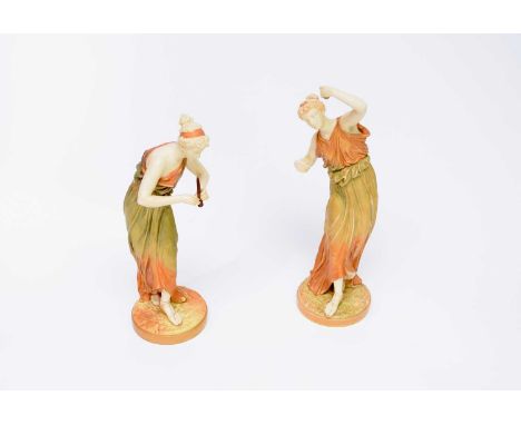 A pair of Royal Worcester blush ivory figures of Grecian Musicians by James Hadleyone with cymbals and the other with a pipe,