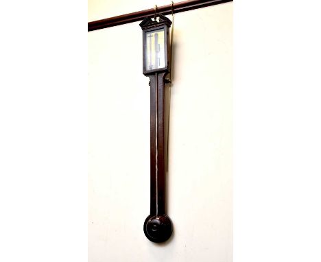 A George III mahogany and checquer strung stick barometer, the broken triangular pediment with an urn finial above a 3.75" br