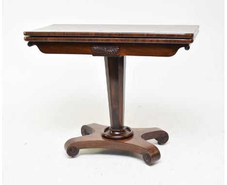 An early Victorian rosewood veneered card table, the rectangular swivel top above a tapering octagonal support, raised on a c