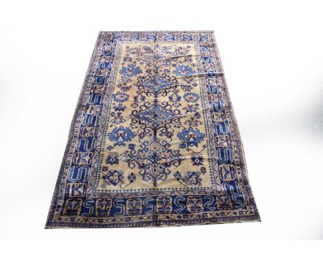 A Turkish village rug, first half 20th century, the central camel field with multiple blue guls, within a conforming border b