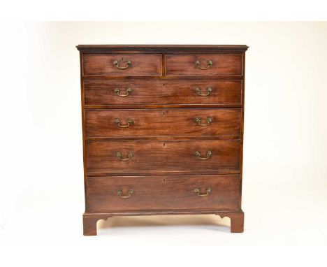 A George III mahogany chest of drawers, the moulded top with dentil cornice above two short and four long cock-beaded drawers