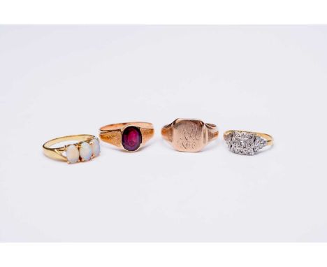 A diamond set cluster ring, stamped '18ct &amp; Plat', ring size K, together with a three stone opal ring, stamped '18k', a y