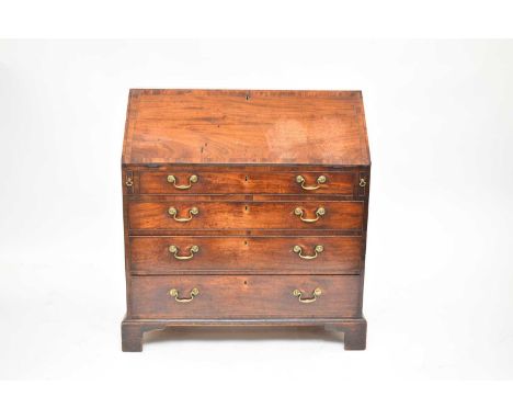 A George III mahogany bureau, the cross-banded fall front opening to a fitted interior with drawers and pigeon holes, above f
