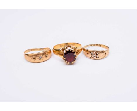 A 22ct gold single stone garnet ring, size T, weight approx 6.8g, together with two 18ct gold diamond set rings, weight appro