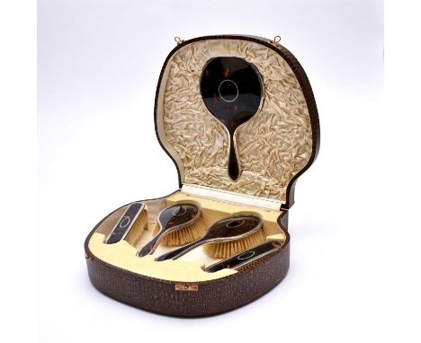 A cased silver and tortoiseshell mounted dressing table set, Walker &amp; Hall, Birmingham 1926, comprising; a hand mirror, t