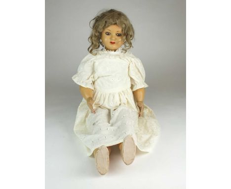 A composite doll, early 20th century, unknown maker, of wood, papier mache and painted gesso construction, with lashed sleepi