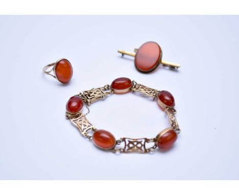 A Carnelian matched suite of jewellery, comprising; a 9ct gold bracelet, a yellow metal bar brooch, stamped '9ct' and a singl