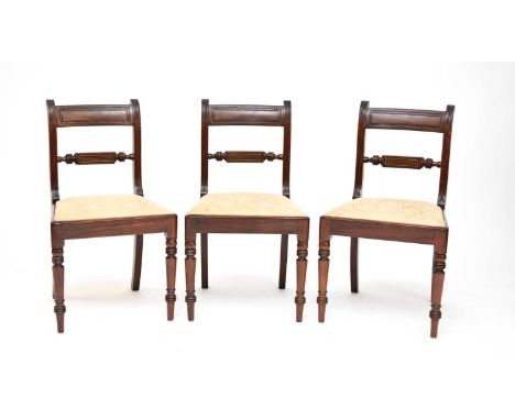 A set of 6 Regency mahogany dining chairs each with a ‘panelled’ bar back above a rail with brass stringing, over a slip-in s