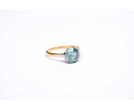 A blue zircon single stone ring, the mixed cut blue zircon claw set in white metal to yellow metal shank, stamped '18ct plat'