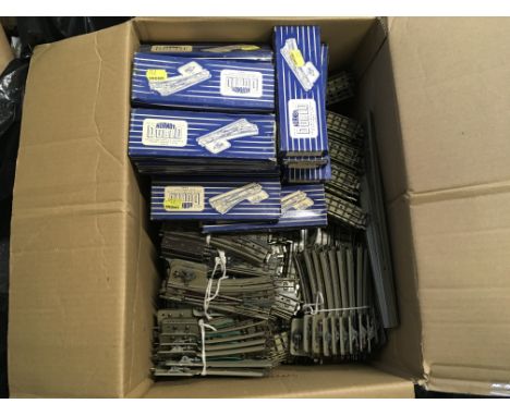 A box containing a large amount of model railway track by Hornby Dublo. Includes both boxed and loose pieces.