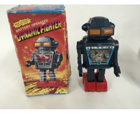 A boxed battery operated robot made in Japan by JUNIOR. Called DYNAMIC FIGHTER item no. 1023 comes in box which is worn and t