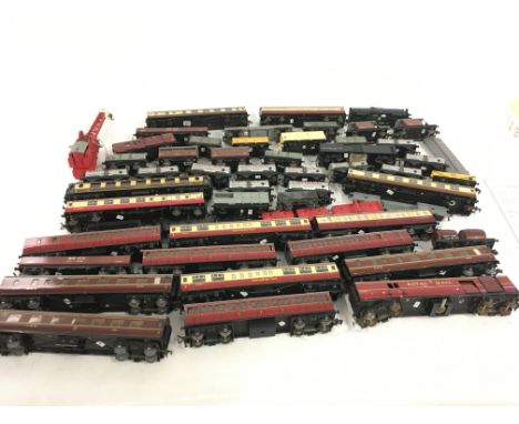 A collection in excess of 50 pieces of model railway carriages and wagons both tinplate and plastic. 00 gauge mainly by Hornb