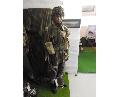 A standing mannequin wearing 1944-46 Airborne Division uniform including smock, denison, jacket, webbing belt, pouches, with 