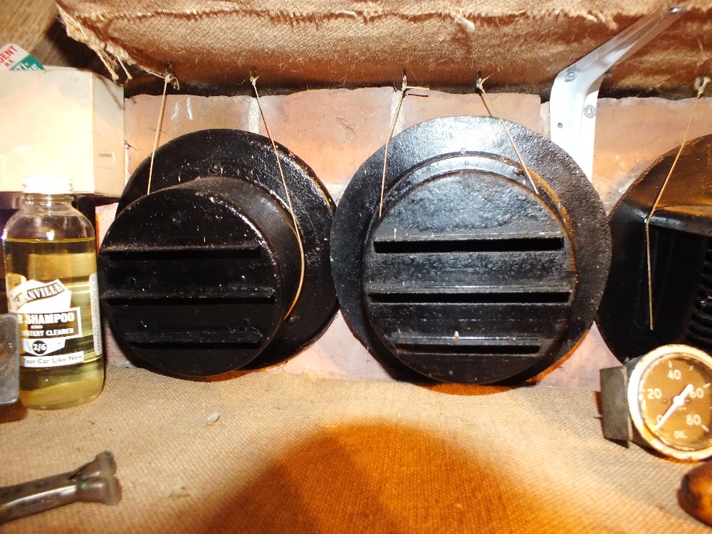Two matched WW2 black painted metal headlight covers with triple louvre