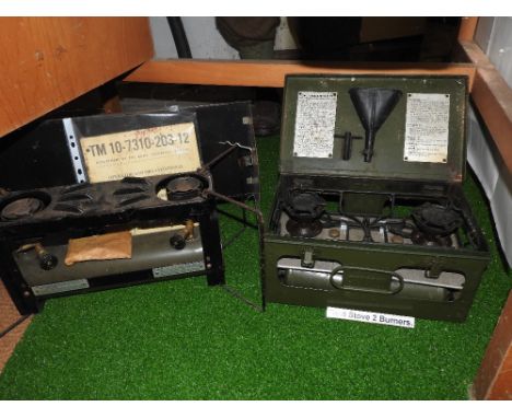 Two field stoves each with two burners, with American Department of the Army Technical Manual.