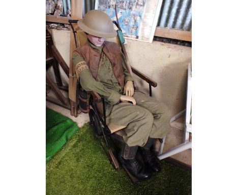 A mannequin wearing a Home Guard uniform, with canteen bottle, leather jerkin, boots and hat
