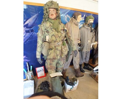 A standing mannequin wearing D.P.M battledress, '58 pattern', with webbing, grenade, SLR magazine, SLR bayonet, first aid kit