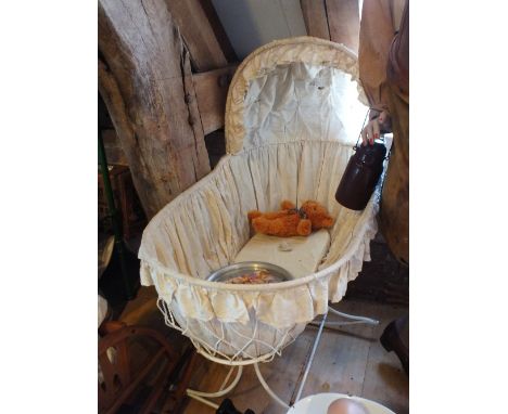 A set of white enamel scales for weighing babies and an oval baby bath on folding stand, child's chamber pot, crib on rocking