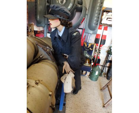 A mannequin leaning forward dressed in blue WRAF uniform