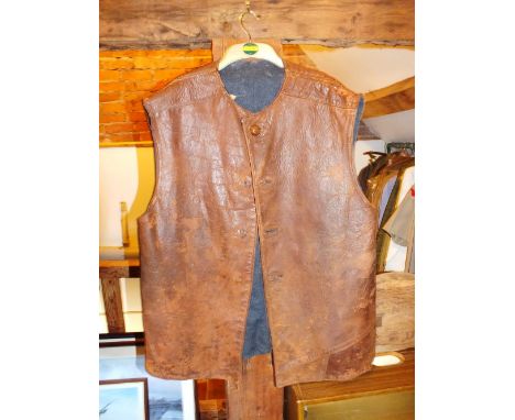 A brown leather jerkin together with a quilted inner waistcoat, a 1965 woollen shirt in khaki, size 15, a combat blouse and a