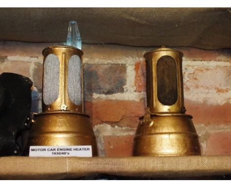 Two 1930s/40s motor car engine heaters along with an oil lamp etc