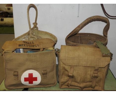 A WWII British Army medics' canvas shell dressing shoulder bag and contents along with a further shoulder bag and two canvas 