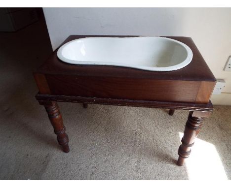 A Victorian mahogany baby bath with original ceramic pot, 47 cm (h) x 56 cm (w) x 36cm (d)