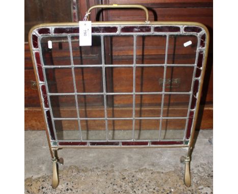 Stained glass fire screen with a brass surround and handle. 